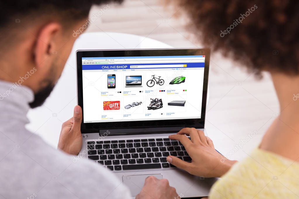Close-up Of A Couple Using Laptop For Shopping Online